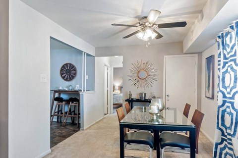 a dining room with a table and a ceiling fan