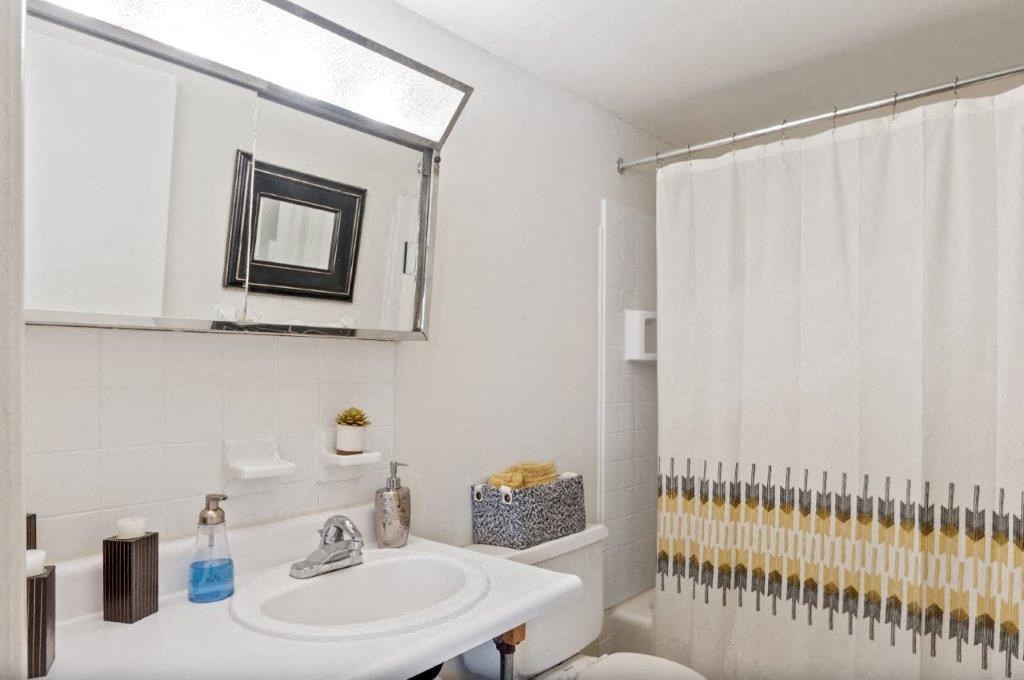 a bathroom with a sink and a mirror and a toilet