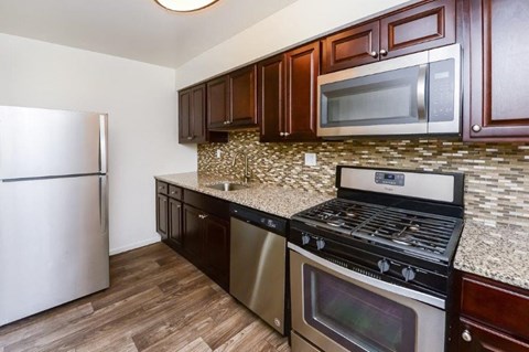 a kitchen with stainless steel appliances and granite counter tops