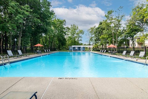 a large swimming pool with chairs around it