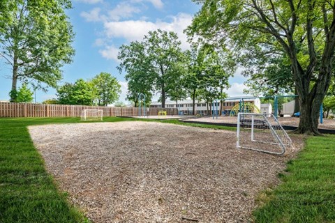 the park has a playground and a chain link fence