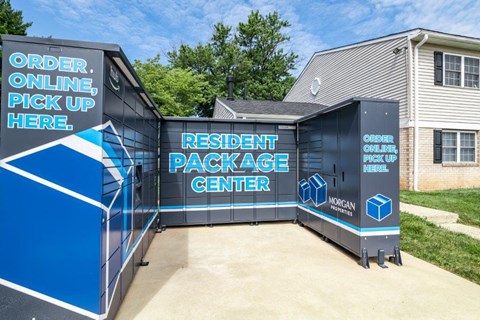 an enclosed parking lot with a rental package center sign on a building