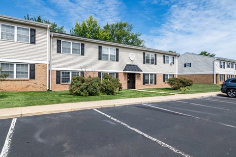 an empty parking lot in front of an apartment building