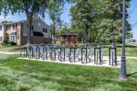a row of bikes parked on a sidewalk