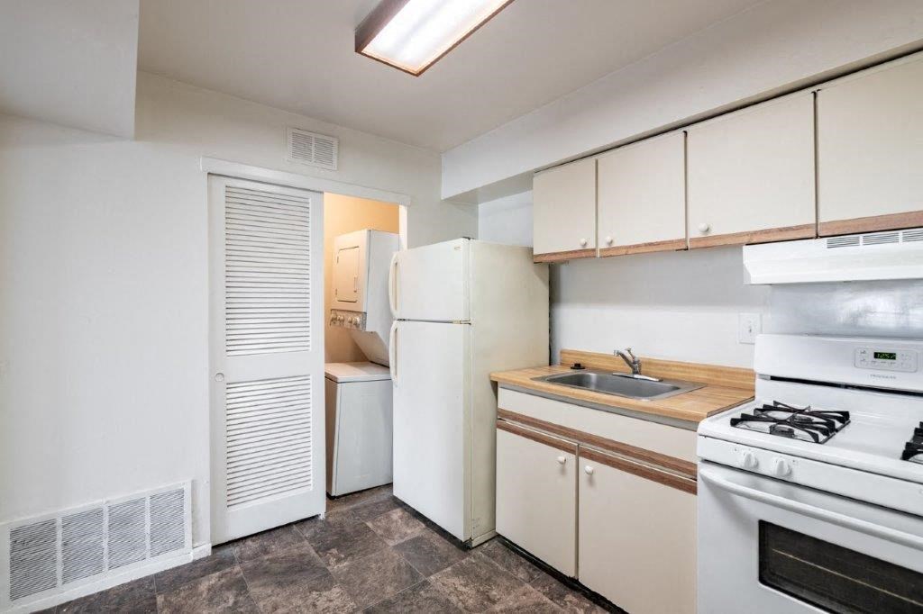 a kitchen with a stove refrigerator and a sink