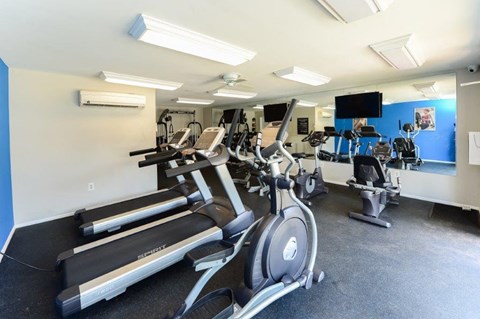 a gym with various pieces of exercise equipment