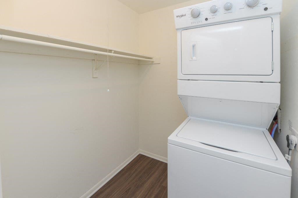 a white washer and dryer in a room with a closet
