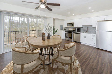 a kitchen and dining room with a table and chairs