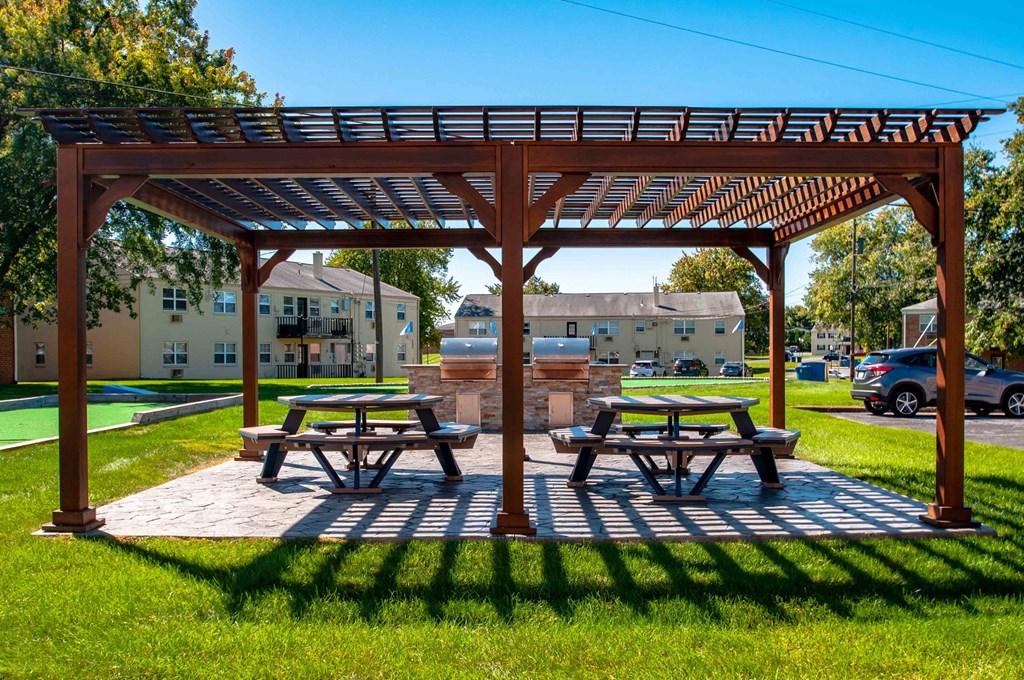 a picnic area with picnic tables and a water fountain