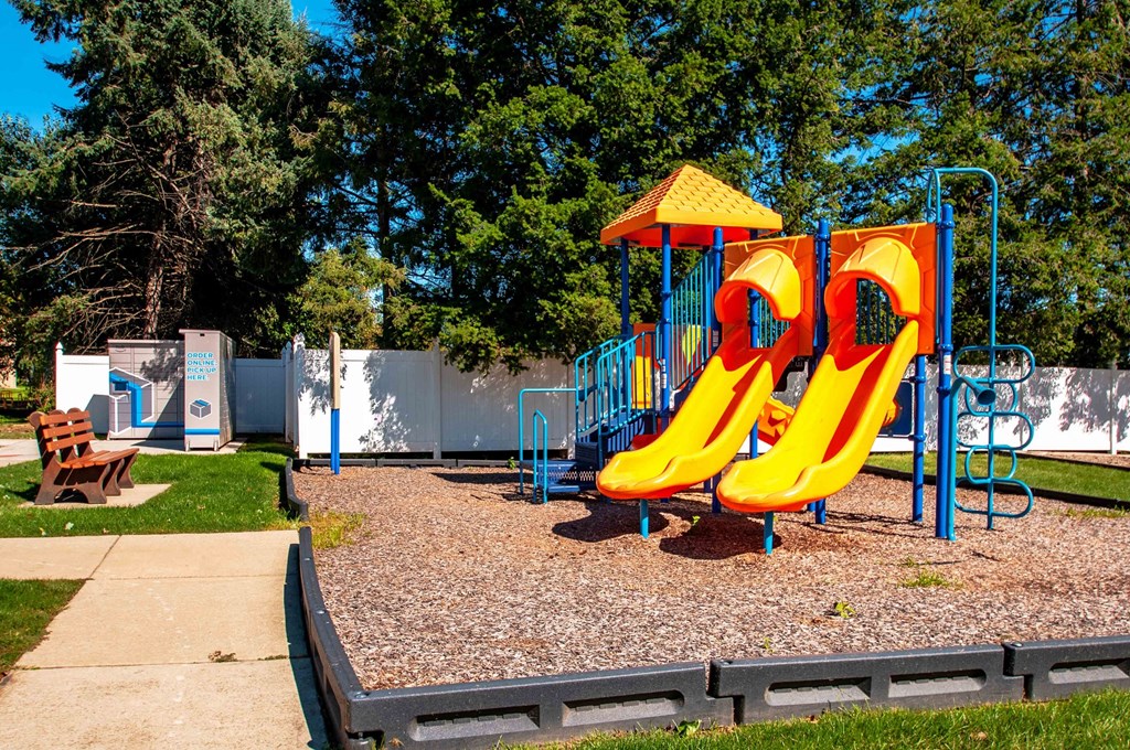 a playground at a park with a yellow slide