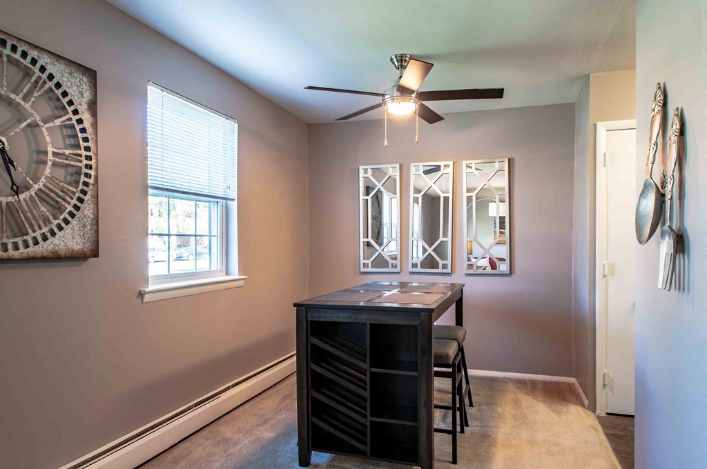 a dining room with a table and a ceiling fan