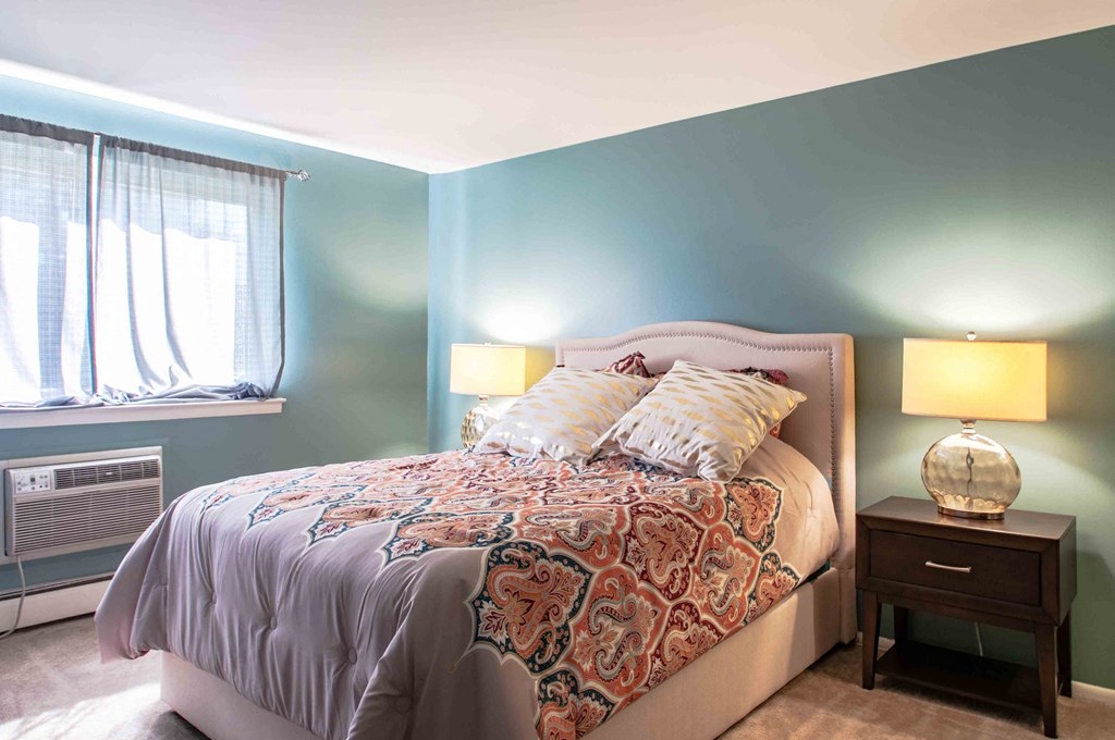 a bedroom with a bed and a window