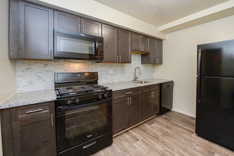 a kitchen with a stove and a microwave