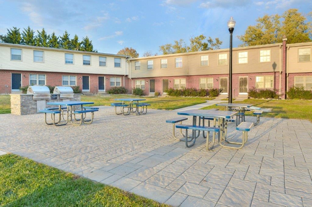 our apartments have a large patio with tables and benches
