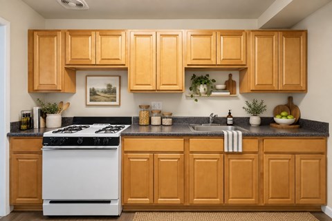A kitchen with wooden cabinets and a white stove.