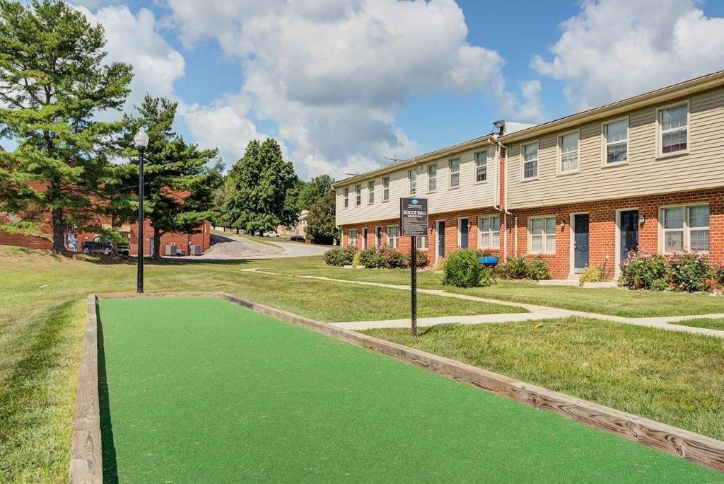 a building with a green lawn and a sign in front of it