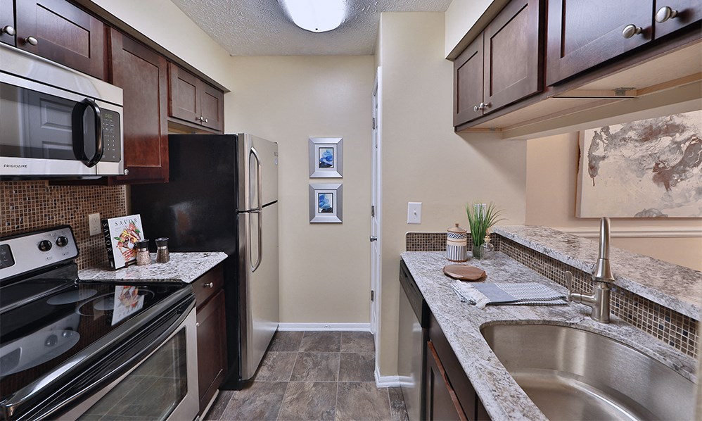 a kitchen with stainless steel appliances and granite counter tops
