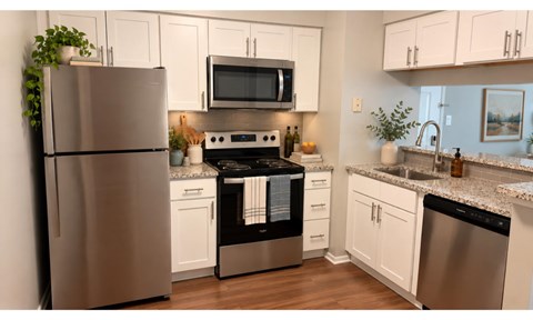 A modern kitchen with a stainless steel refrigerator and a black oven.