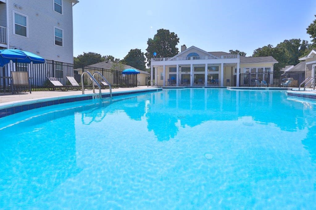 a large swimming pool with a building in the background