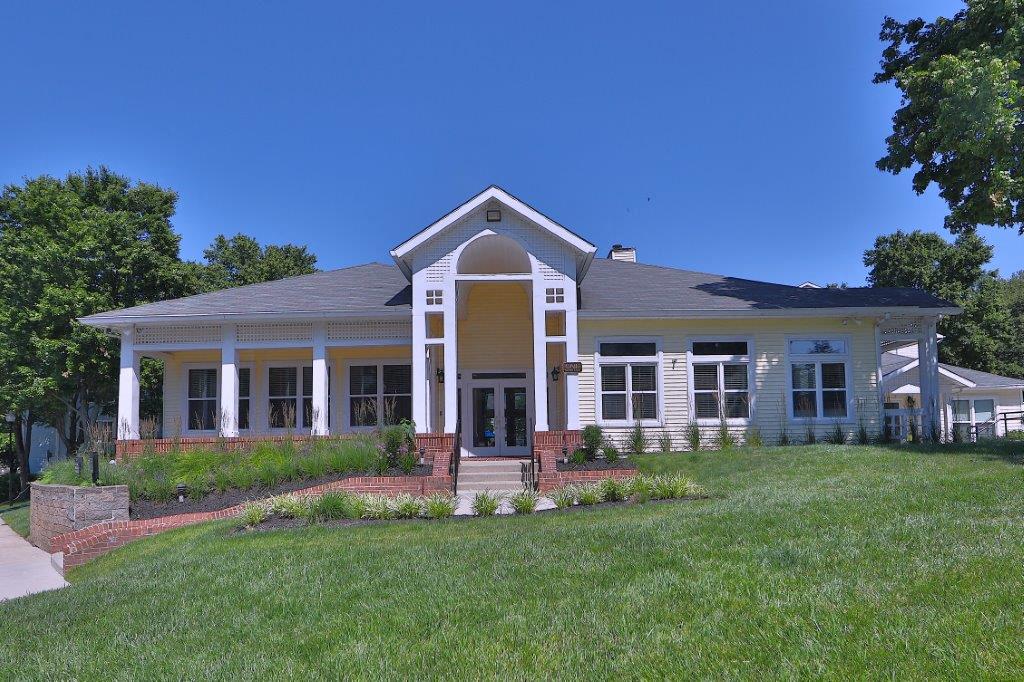 a white house with a lawn in front of it