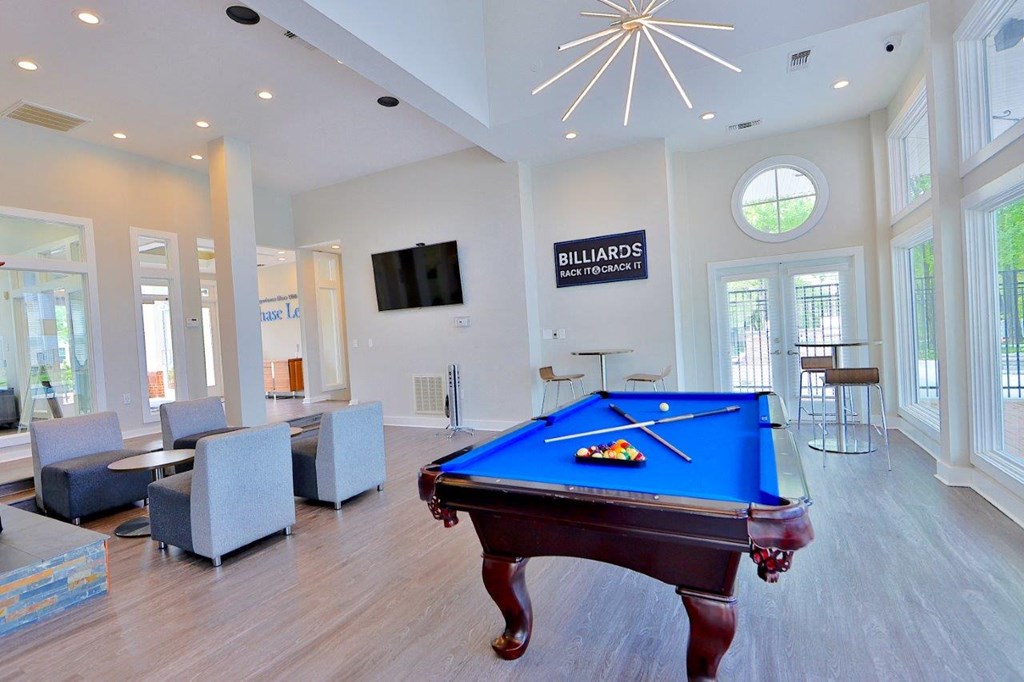 a game room with a pool table and a tv