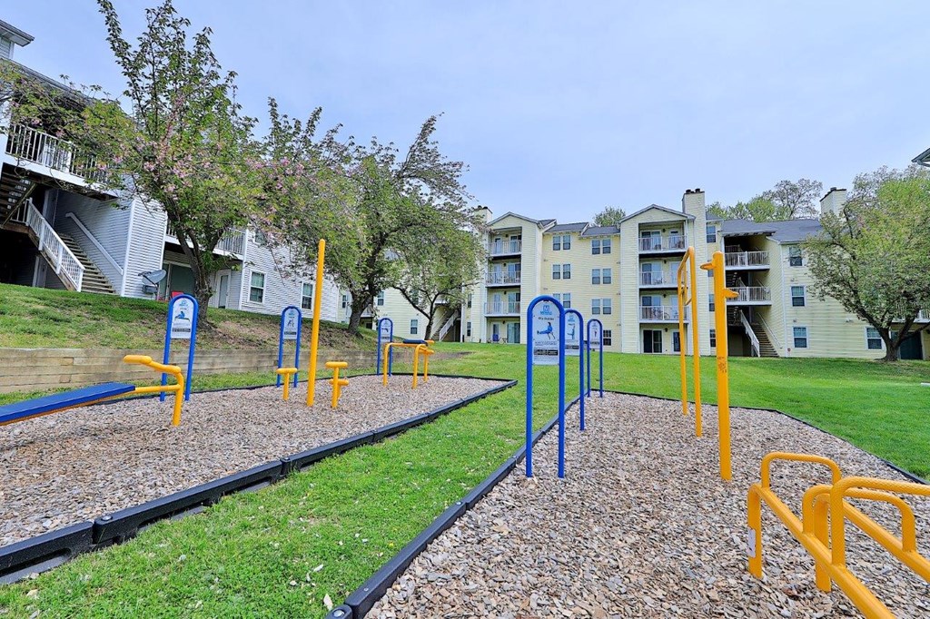 an empty playground in front of an apartment building