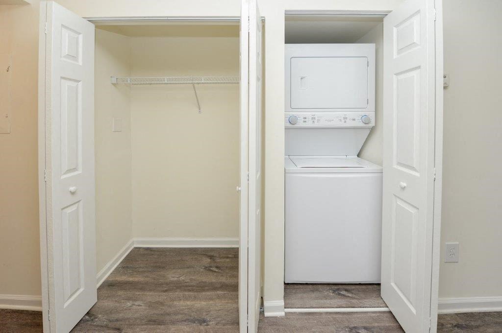 a small closet with a washer and dryer in it