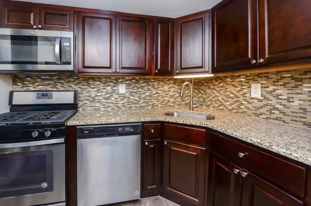 a kitchen with stainless steel appliances and a granite counter top