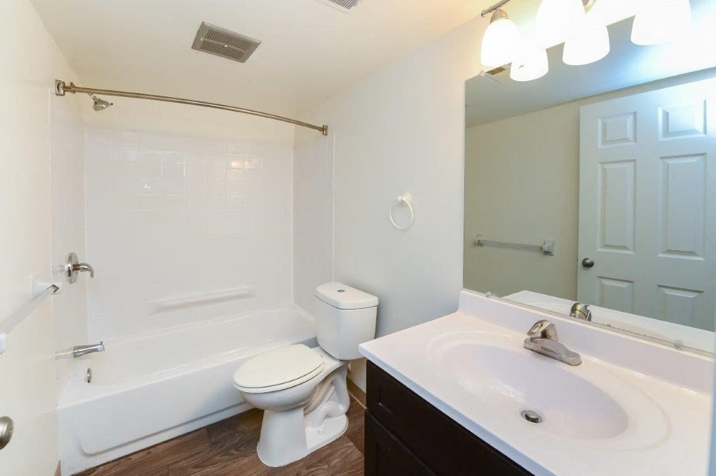 a bathroom with a sink toilet and a bath tub