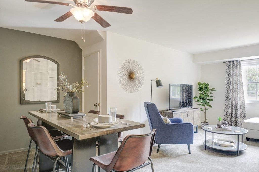 a living room and dining room with a table and chairs