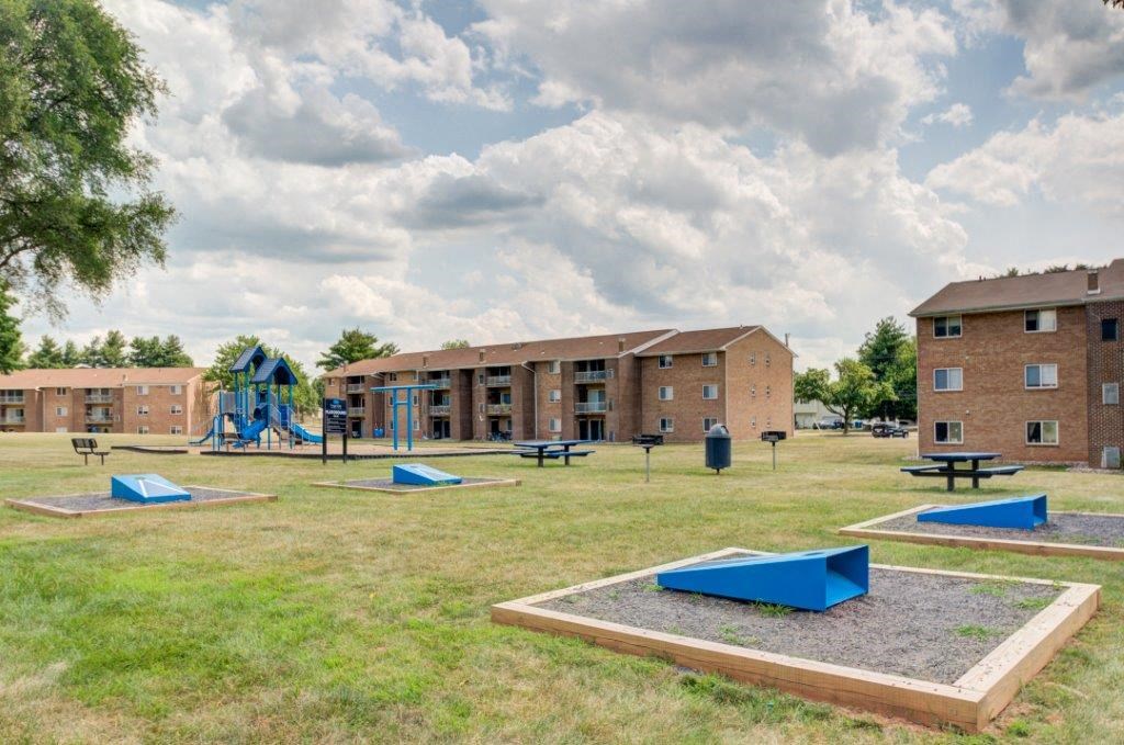 a playground at an apartment complex with playground equipment