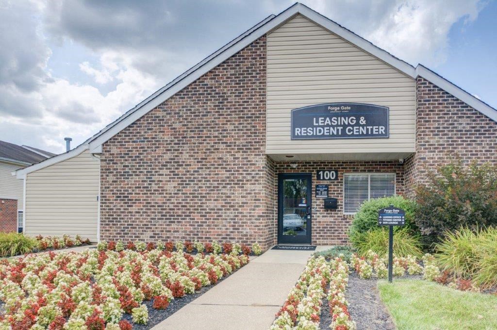 the outside of leasing reserving center in a brick building with a blue sign