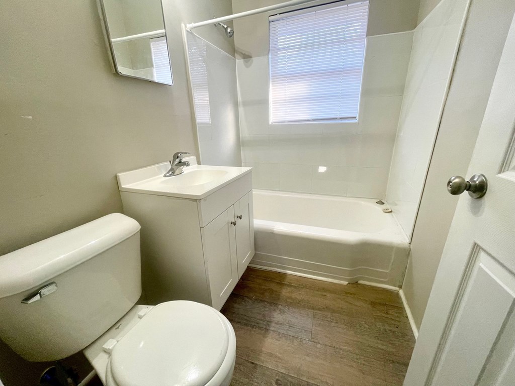 a bathroom with a toilet and a sink and a bath tub