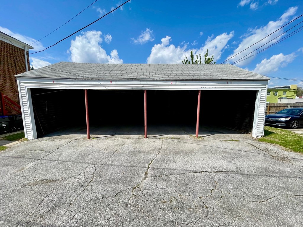 A garage with a grey roof and a concrete floor.