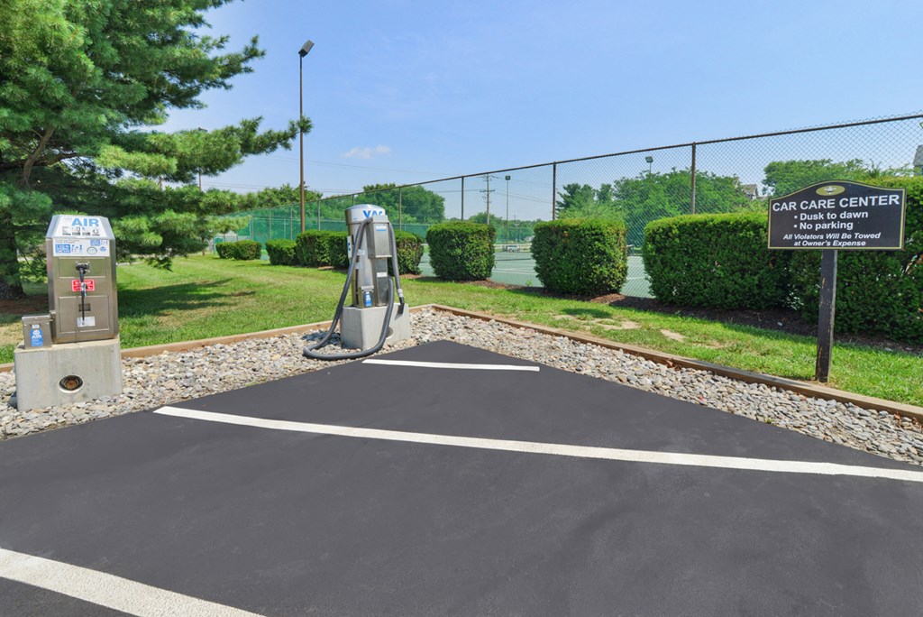 a parking lot with a gas station in front of a fence