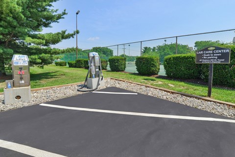a parking lot with a gas station in front of a fence