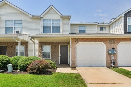 a house with a white garage door and a driveway