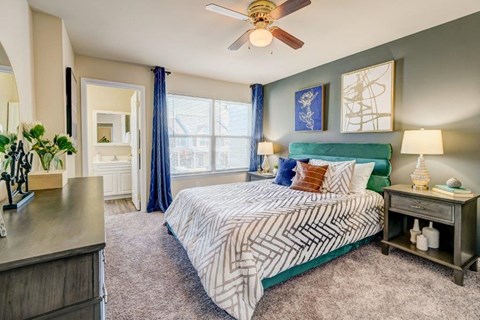 a bedroom with a bed and a ceiling fan