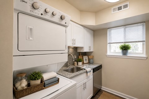 A white oven with a basket of plants on the counter.