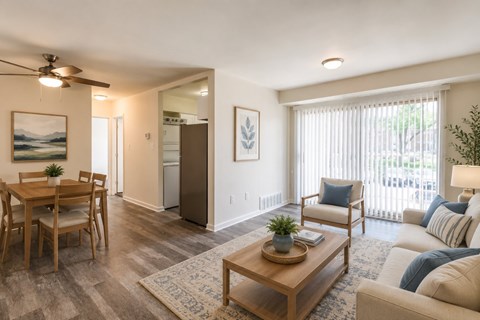 A living room with a dining table and chairs.