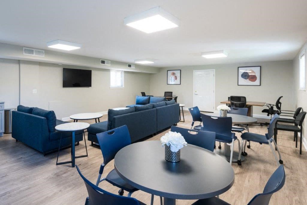 a living room with couches and tables and chairs