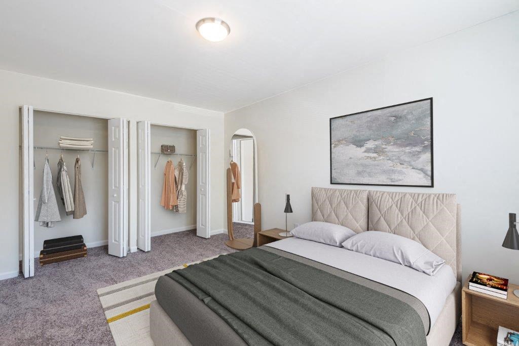 a bedroom with a bed and a closet