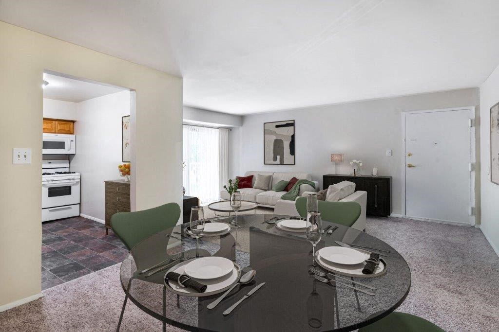 a living room and dining room with a table and chairs