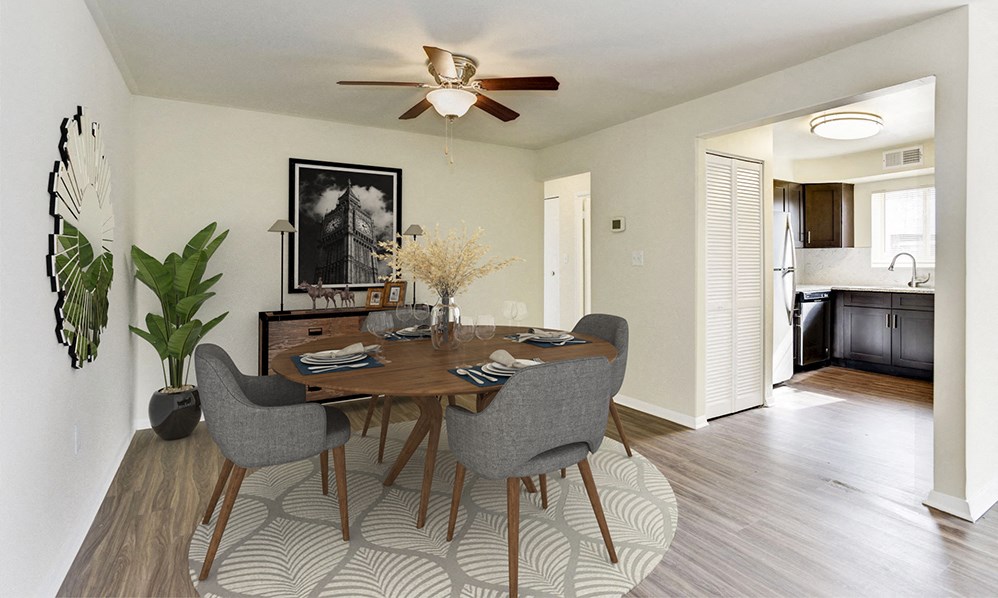 a dining room with a table and chairs and a ceiling fan