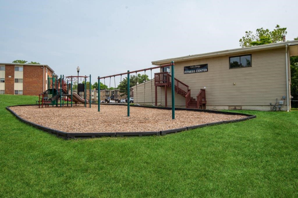 a playground in a yard next to a building