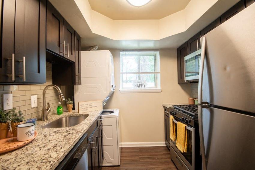 a kitchen with a sink and a refrigerator
