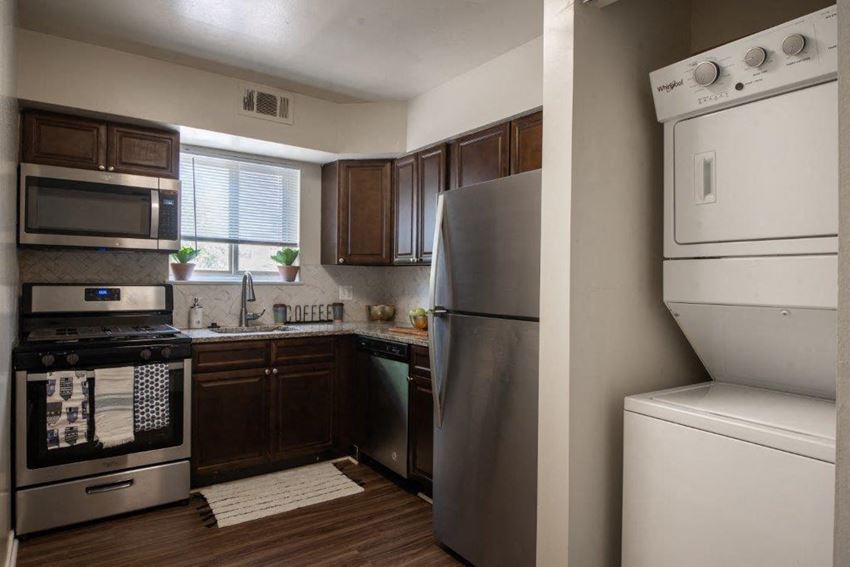 a kitchen with stainless steel appliances and a refrigerator