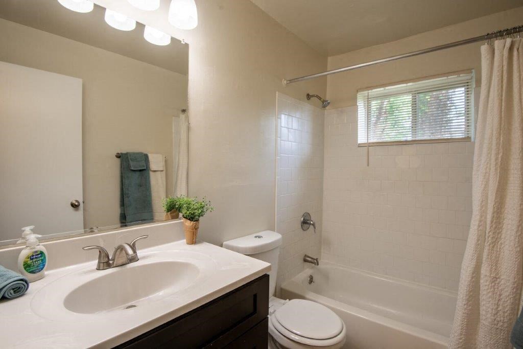 a white bathroom with a sink and a toilet