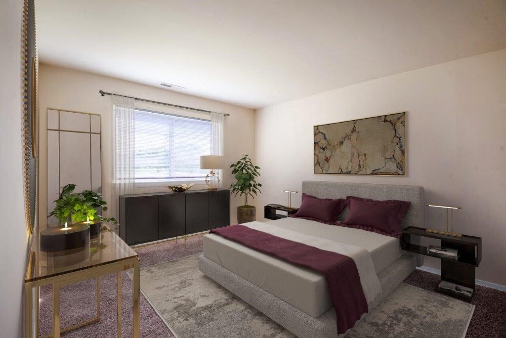 a bedroom with a bed and a couch