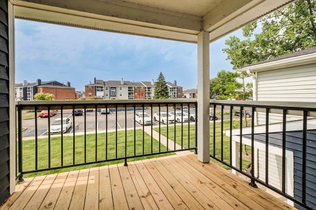the deck has a view of the parking lot and the city in the distance